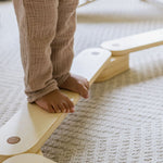 Natural wood balance beam for active play.