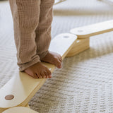 Natural wood balance beam for active play.
