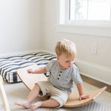 Wooden balance board enhances balance and strength.