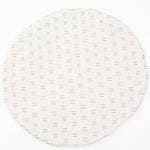 Infant lying comfortably on a thick, padded play mat with educational shapes and textures.