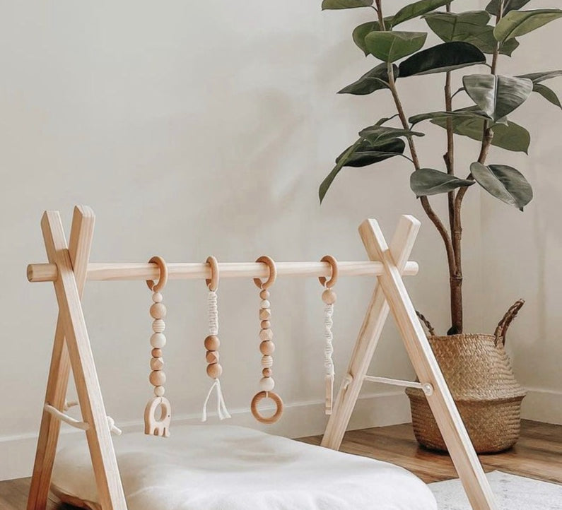 Wooden baby gym featuring natural frame.