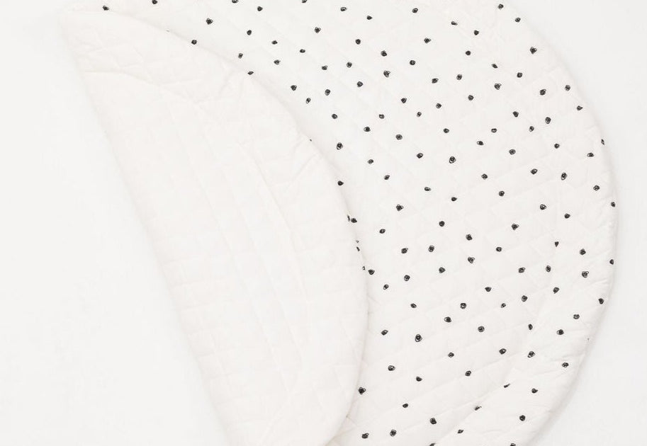 Reversible padded baby play mat with two different designs for versatile play options.