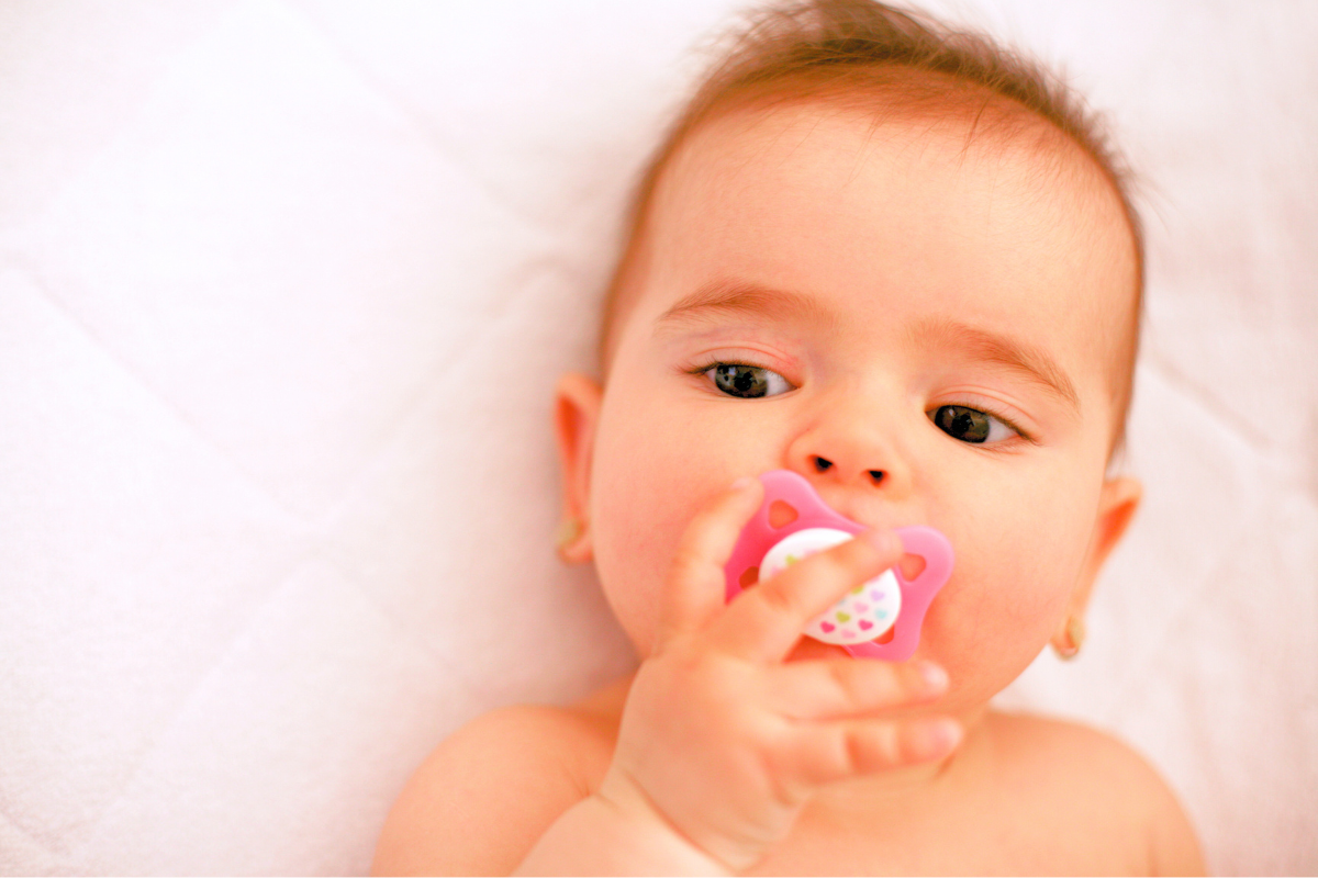 Baby with binkie pacifier in mouth