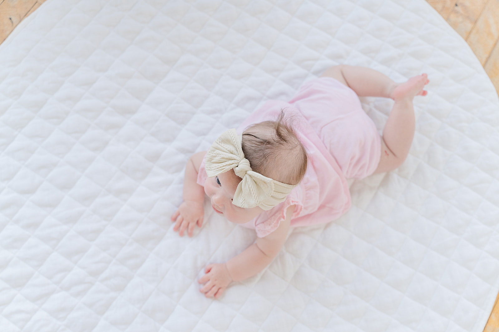 baby lying on the floor mate