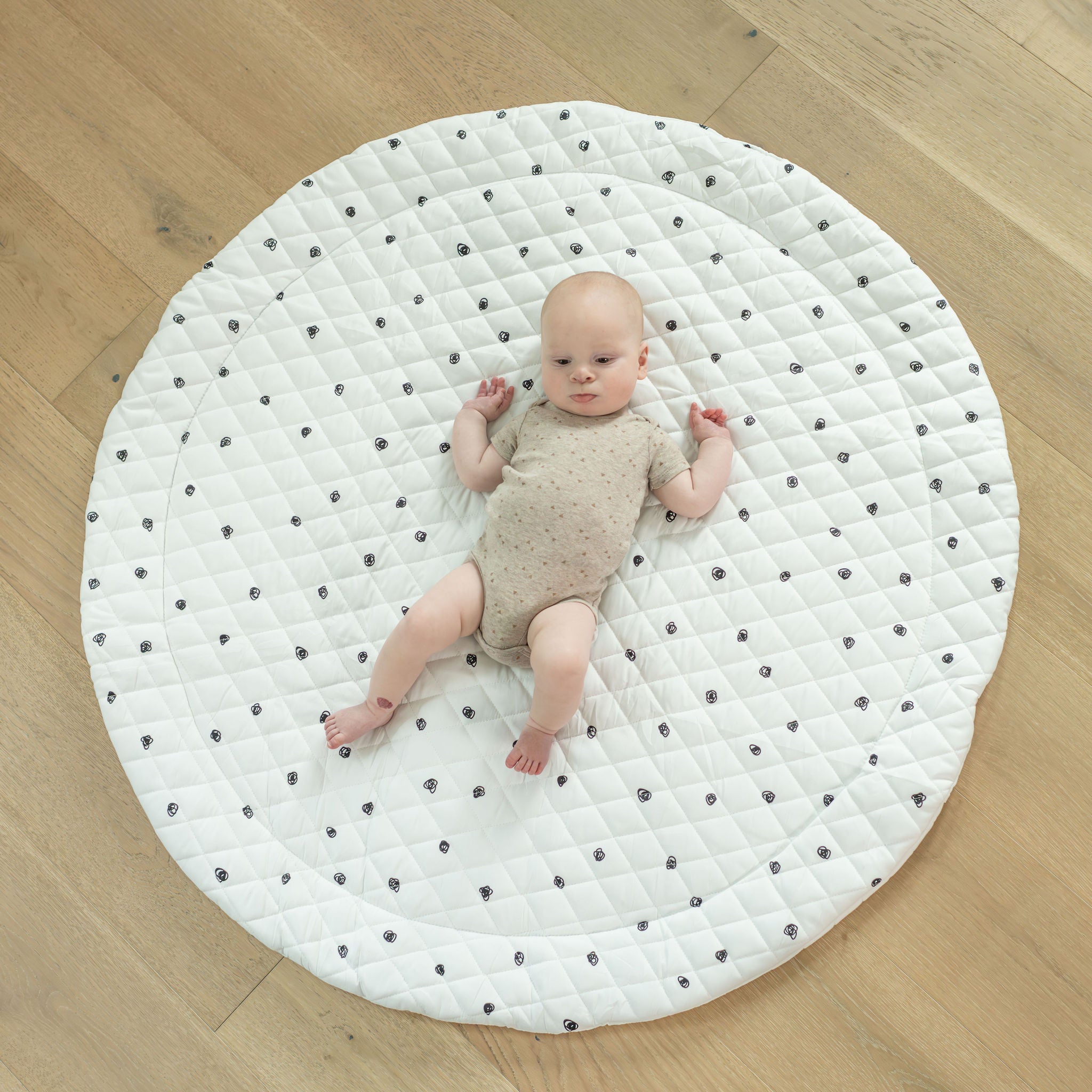 Baby laying on Play Mat by Poppyseed Play