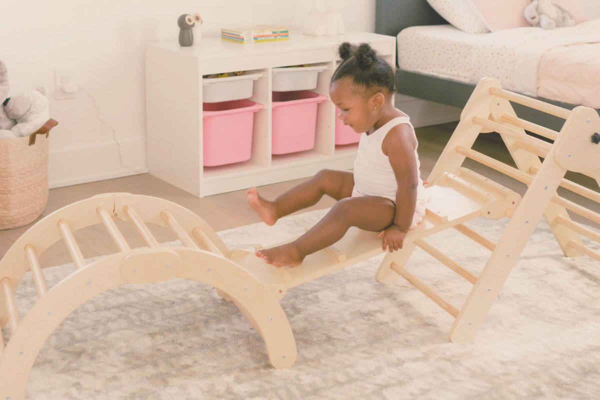 Montessori Climber. Girl climbing on toy