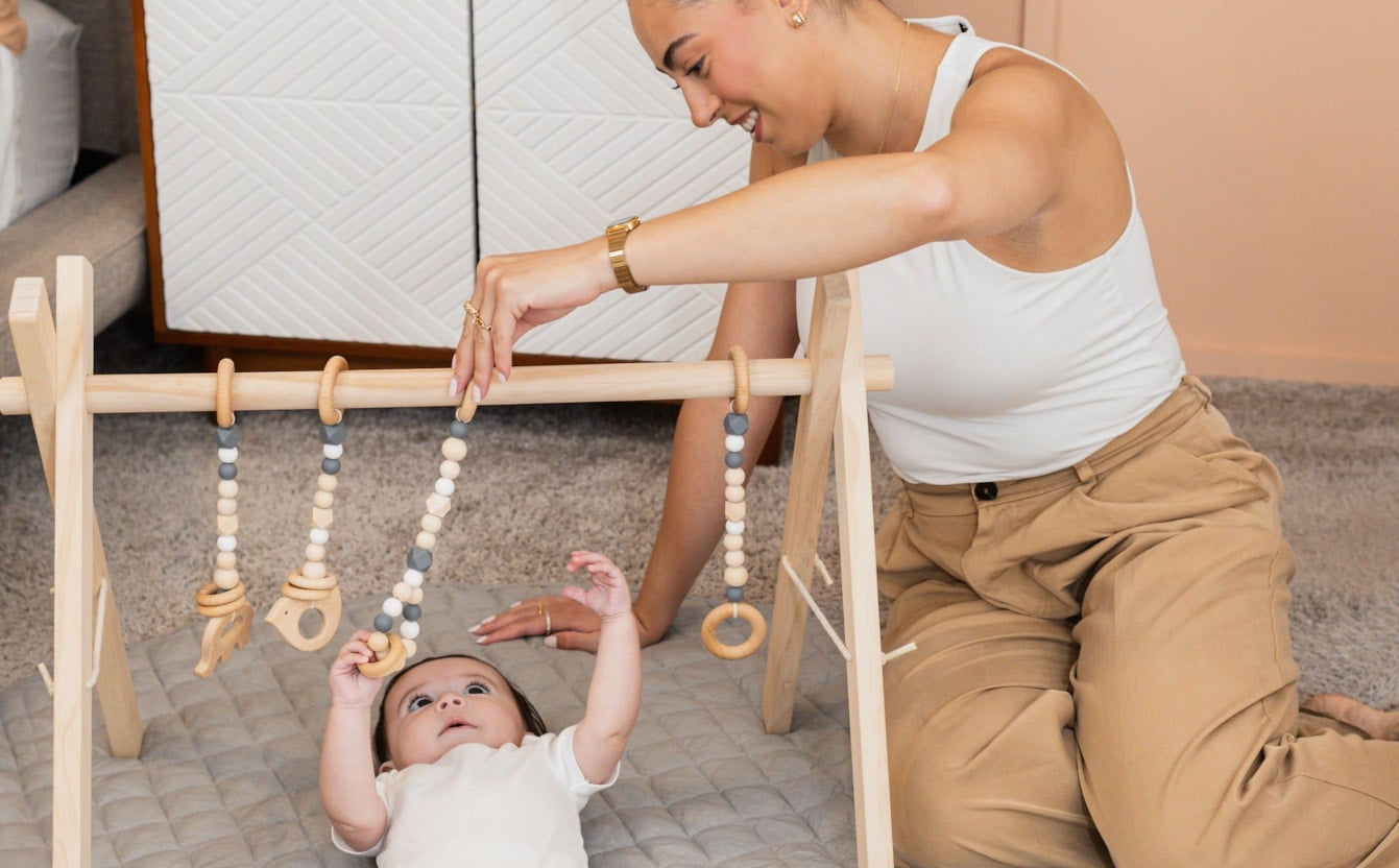 Poppyseed Play Baby Gym with baby and mom