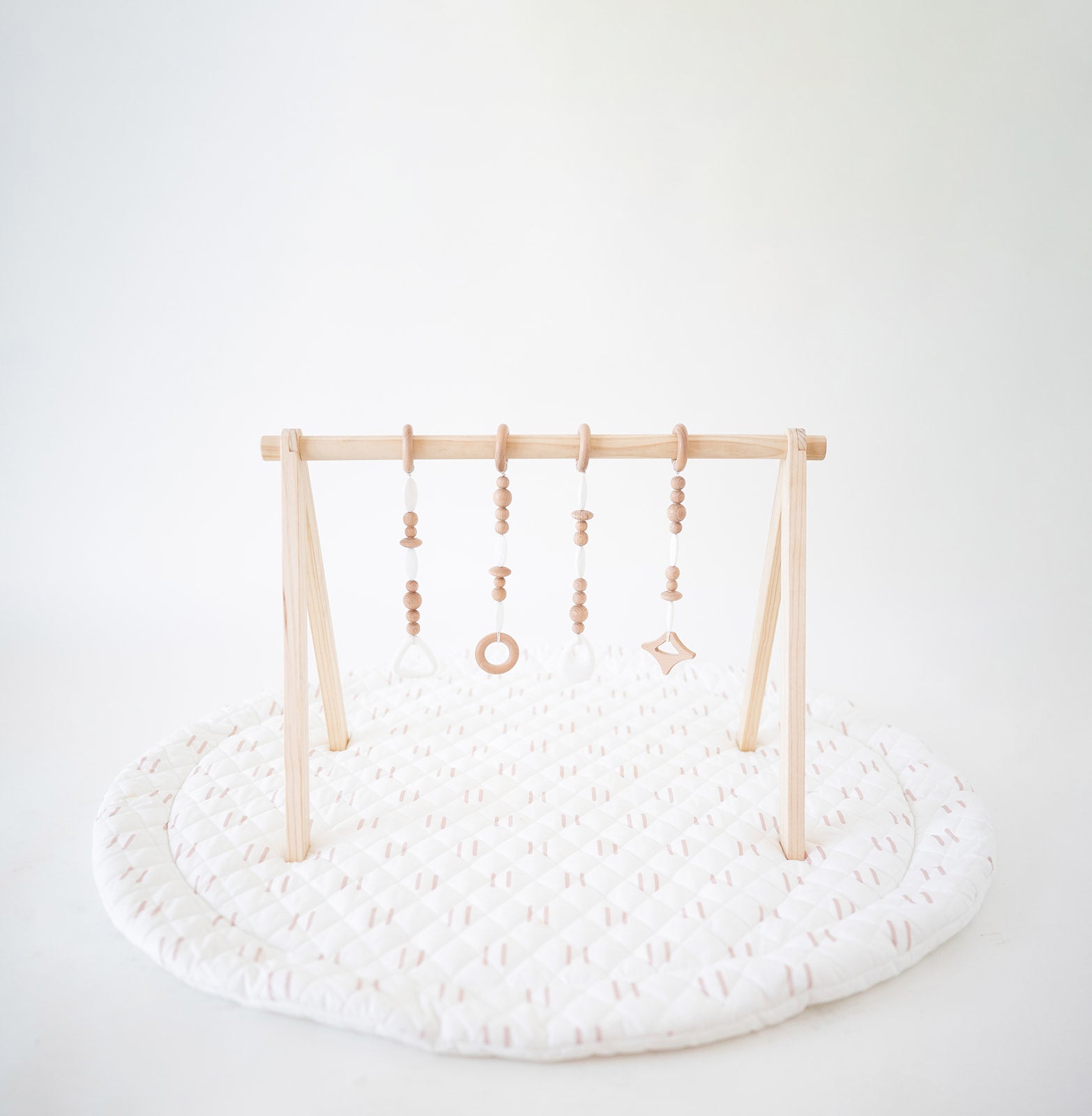 Baby play gym with hanging toys on a white background