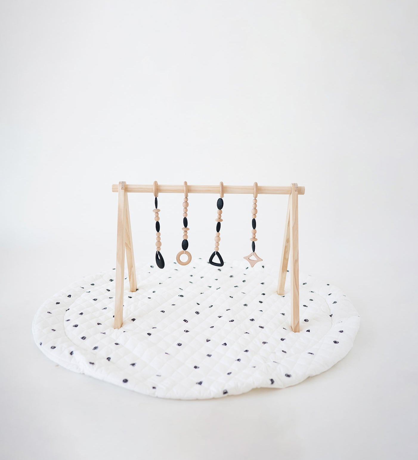 Children's play gym with hanging toys on a white background