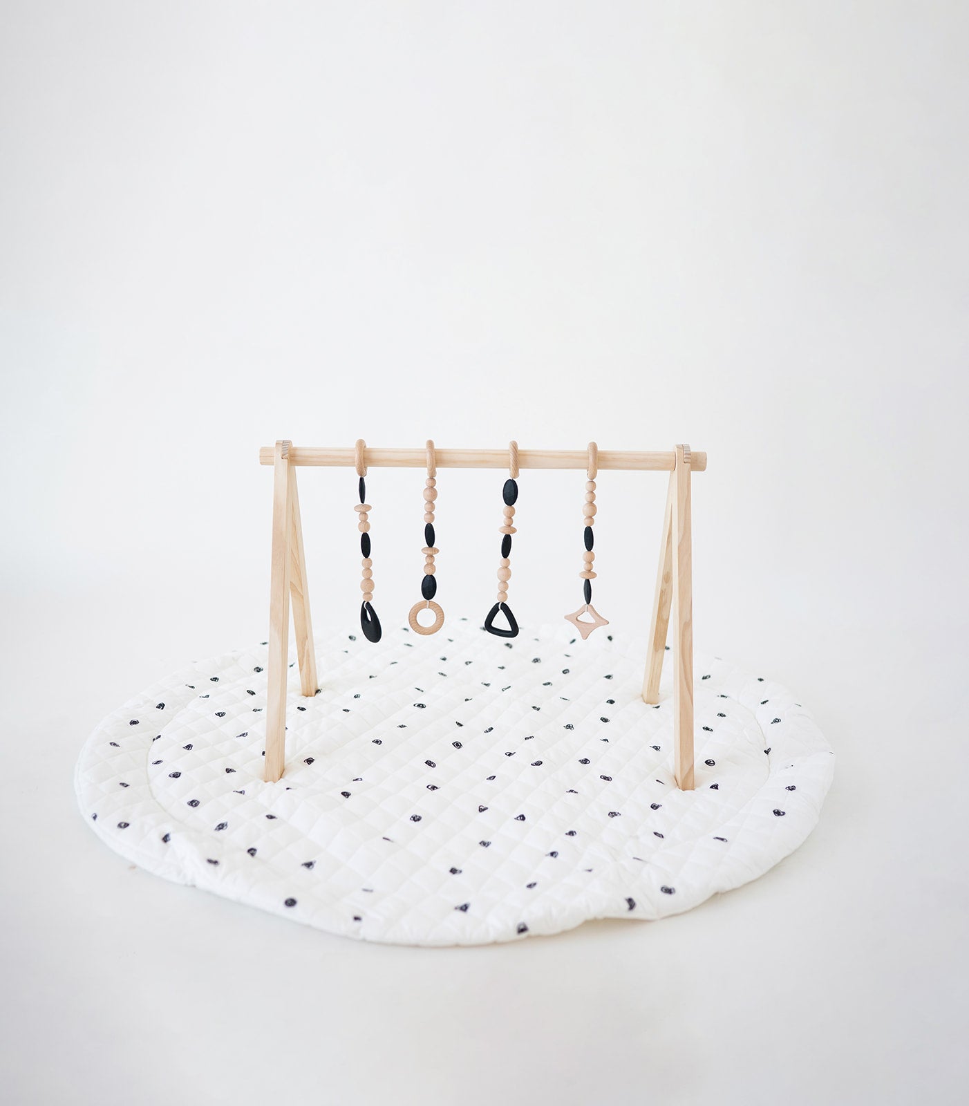 Children's play gym with hanging toys on a white background