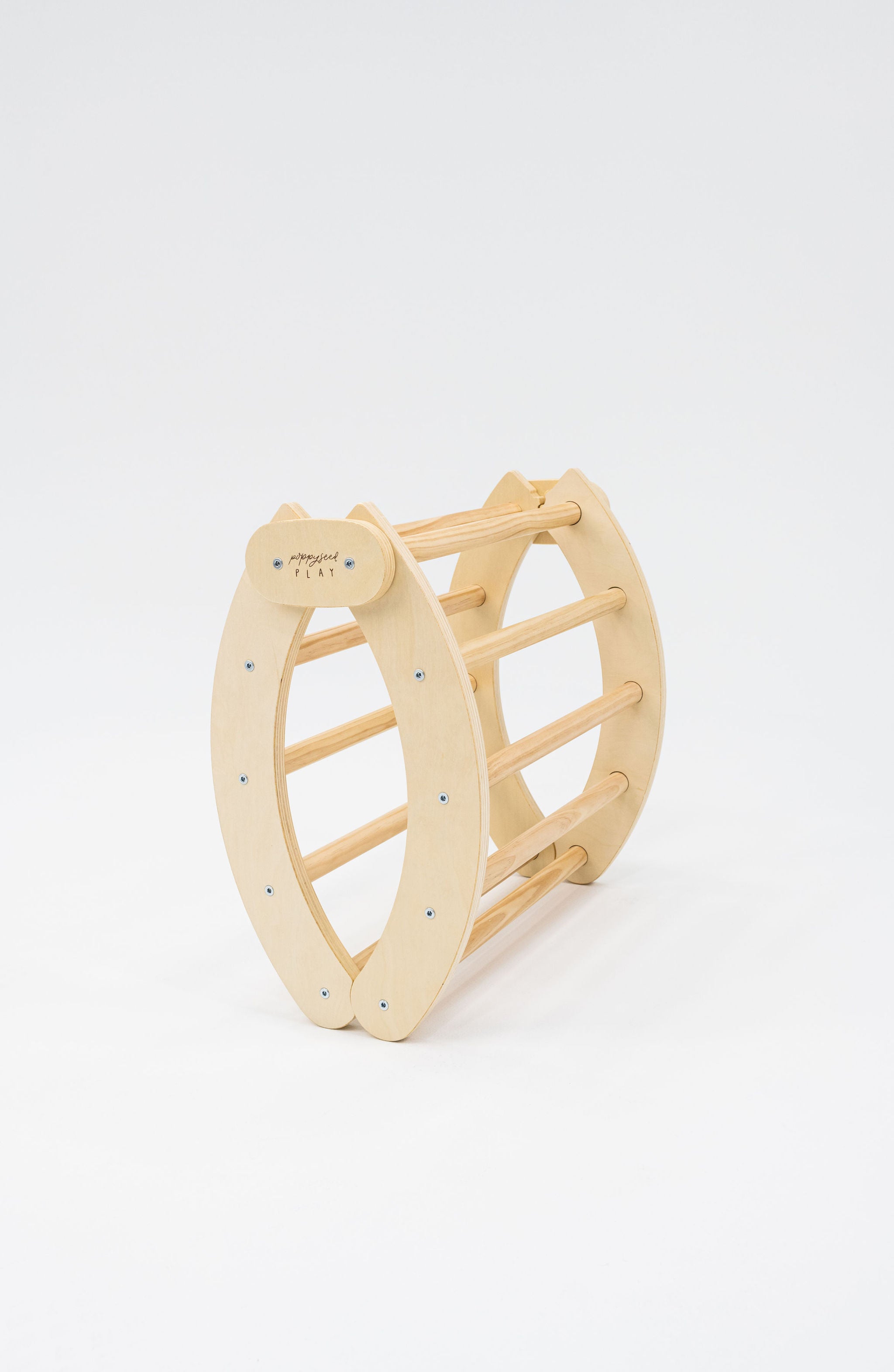 Poppyseed Play Foldable Climbing Arch & Rocker shown in a folded position against a plain white background.
