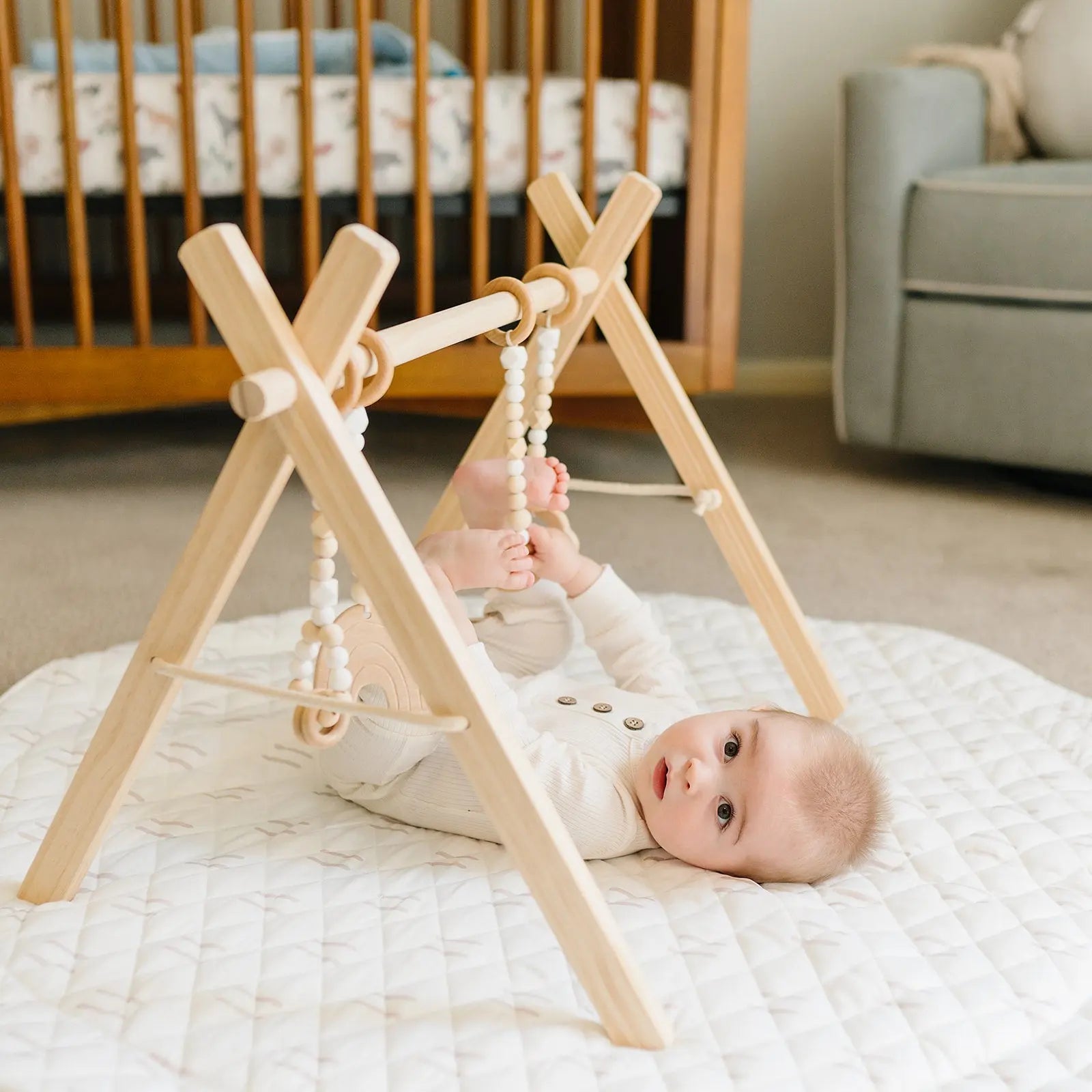 Baby Lying on Play Mat with Gym Overhead