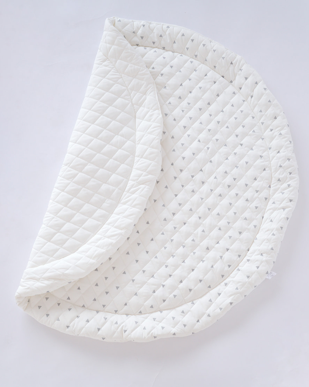 Printed Round Baby Play Mat folded to show its quilted 100% cotton surface	