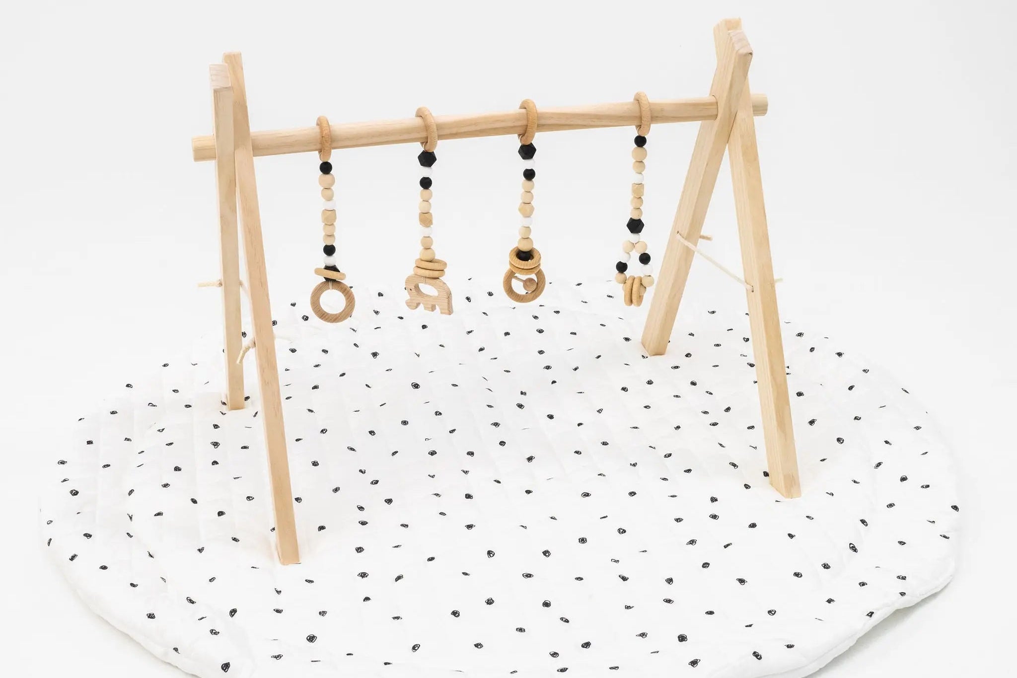 Neutral and black play gym set with soft, calming colors and engaging hanging toys.