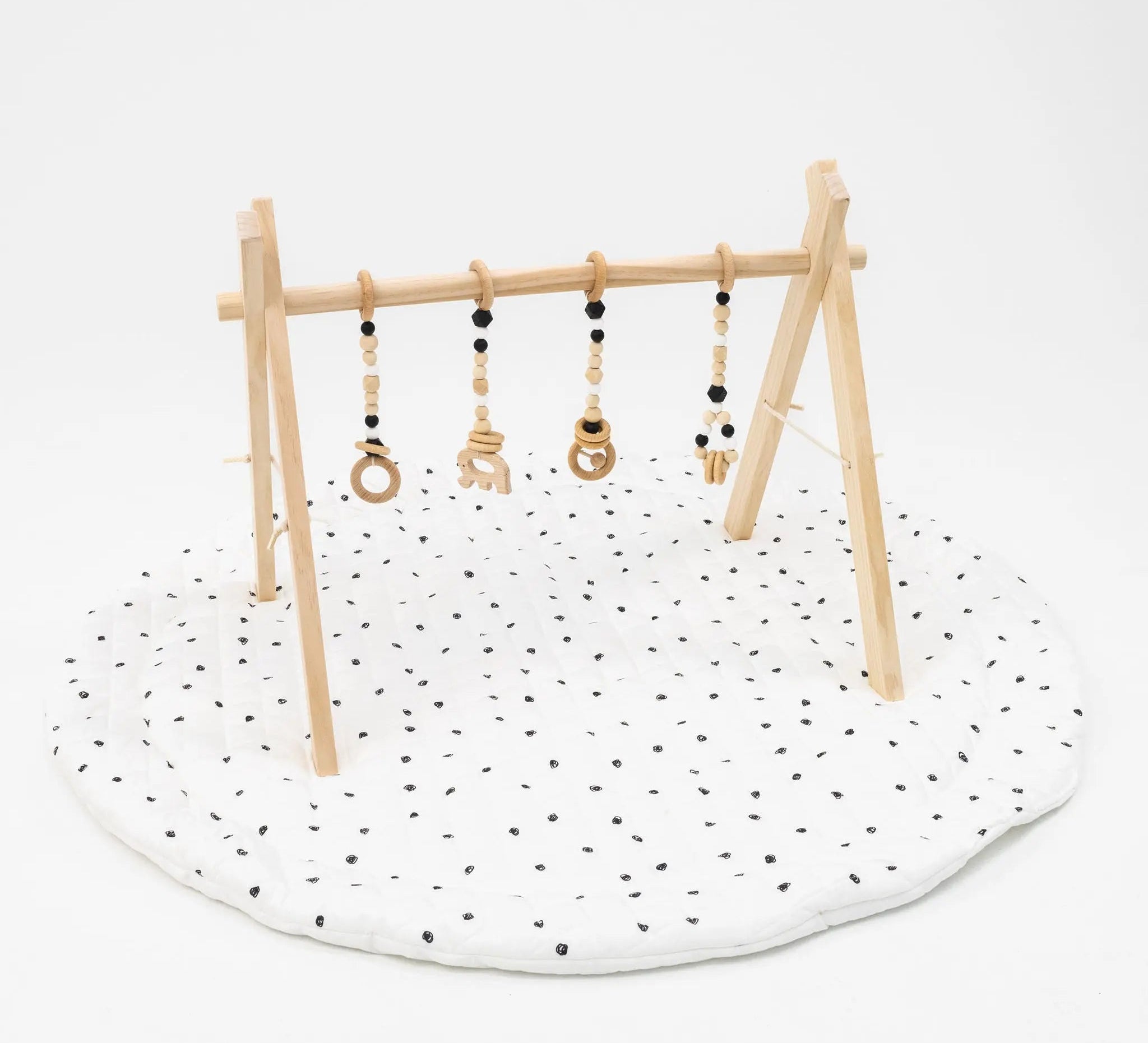 Neutral and black play gym set with soft, calming colors and engaging hanging toys.