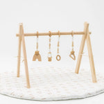 Neutral and white play gym set with soft, calming colors and engaging hanging toys.