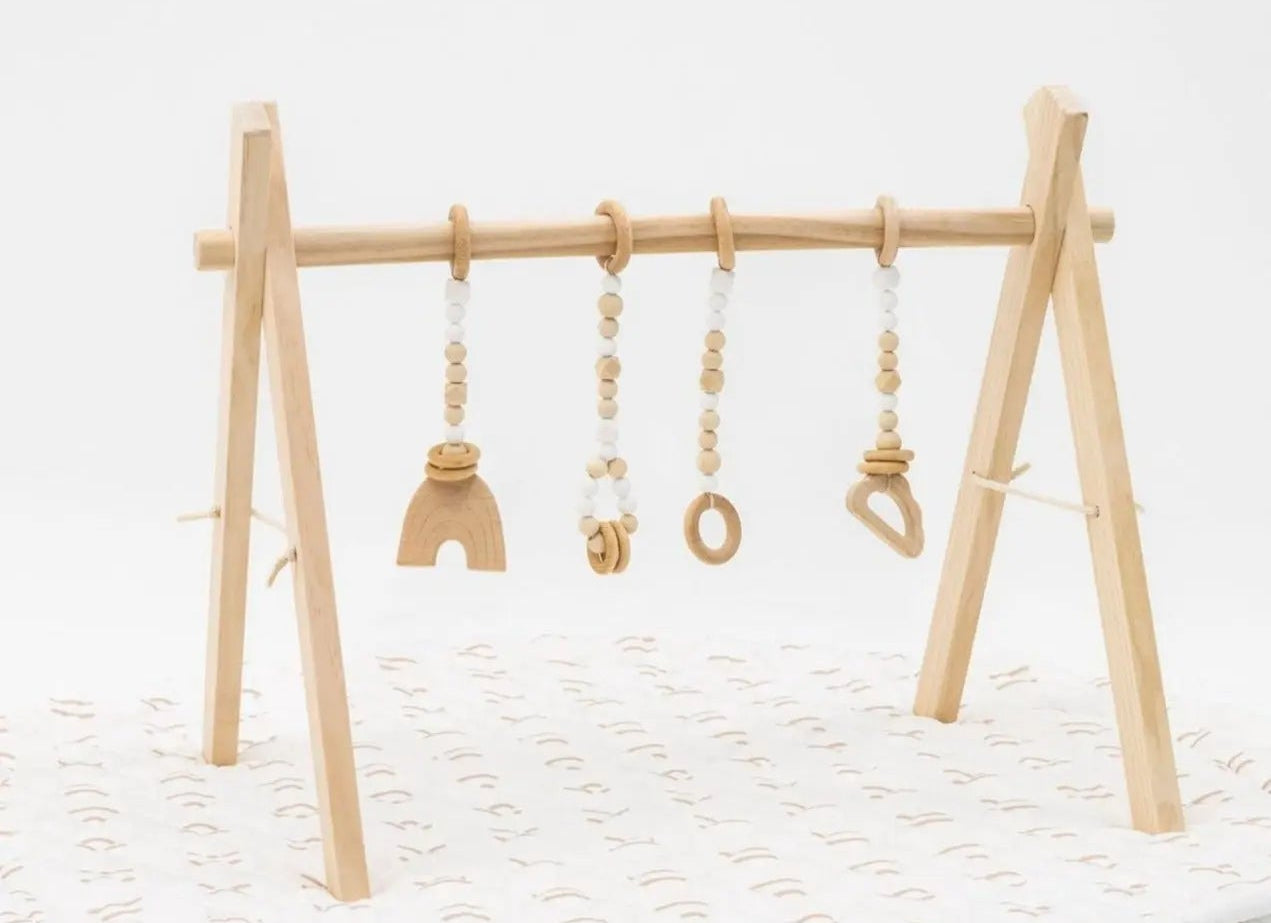 Neutral and white play gym set with soft, calming colors and engaging hanging toys.