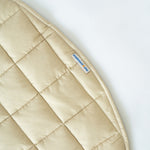 Bound edge and sewn-in tag on the Neutral Round Baby Play Mat